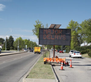 a message board advising of delays along a roadway